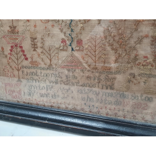 675 - A 19th Century needlework Sampler with decoration of flowers, trees and buildings above indistinct v... 