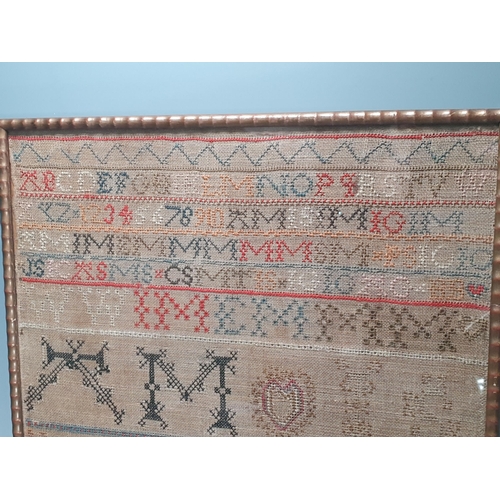 676 - A Victorian needlework Sampler with alphabet, number and other initials above stylised flowers, by M... 