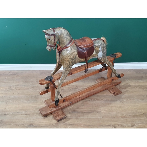 690 - An antique carved and painted Rocking Horse, overpainted, including saddle and stirrups, and mounted... 