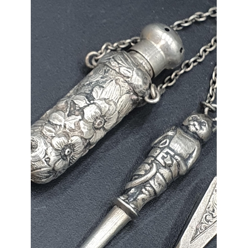 70 - A sterling silver Scarf Clip with leafage engraving, and a white metal Chatelaine with  whistle, sea... 