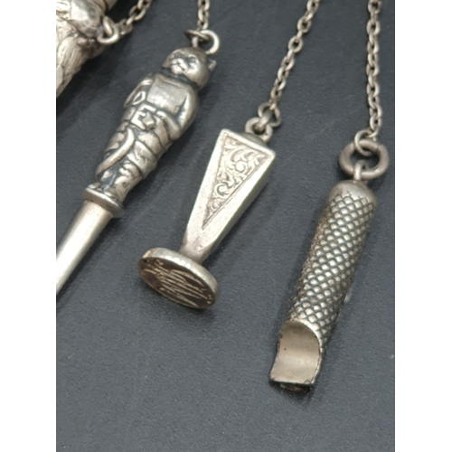 70 - A sterling silver Scarf Clip with leafage engraving, and a white metal Chatelaine with  whistle, sea... 