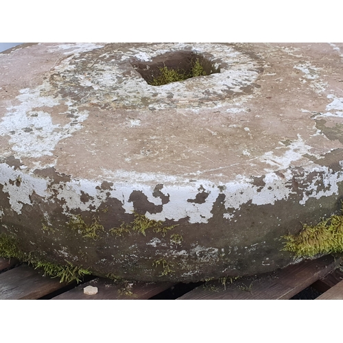 721 - A large circular weathered Mill/Press Stone with square cut hole to centre, approx 3ft 1in Diam