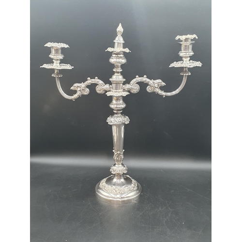 78 - A pair of 19th century Sheffield plated Candlesticks with foliate friezes fitted two branch surmount... 