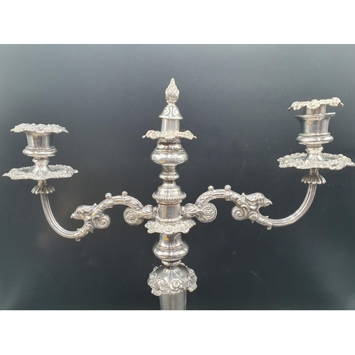 78 - A pair of 19th century Sheffield plated Candlesticks with foliate friezes fitted two branch surmount... 