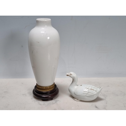 816 - A blanc de chine baluster vase with ormolu foot on wooden stand, and a white porcelain 