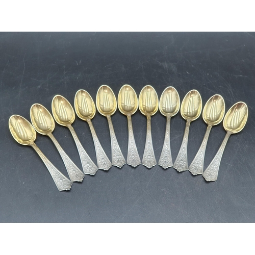 82 - Eleven sterling silver Spoons with ornate stems and gilt bowls, engraved initials, 190gms