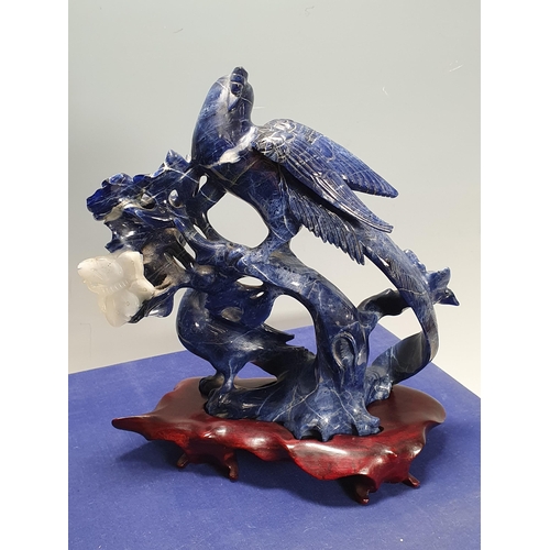 822 - A Chinese Lapis Lazuli carved Figure of a pair of birds perched on a flowering branch with a butterf... 