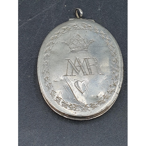 87 - An oval white metal Pendant engraved crown over initials MAR and heart, opening to reveal rolled pap... 