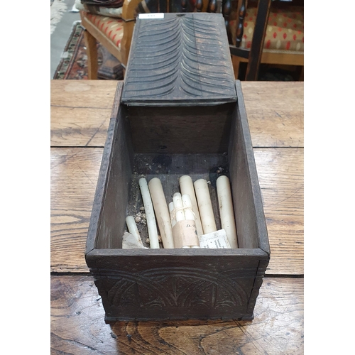 691 - An antique oak Candle Box with sliding lid with carved leafage design, the sides and ends with carve... 