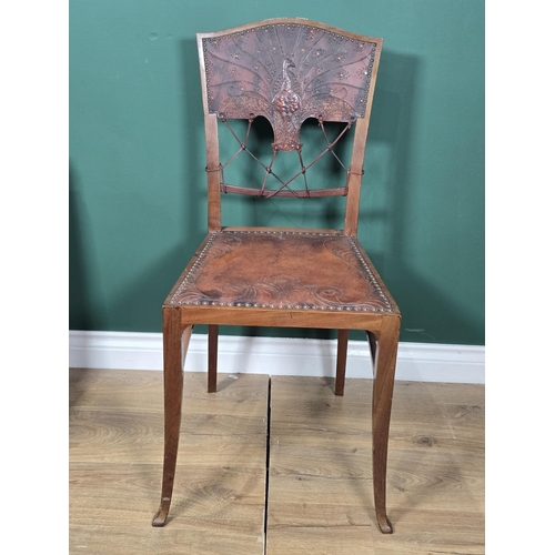 411 - An early 20th century Aesthetic Movement mahogany Hall Chair with peacock embossed leather back and ... 