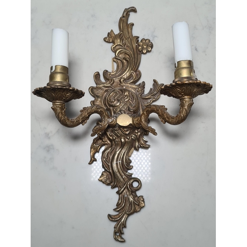 695 - A pair of gilt metal two branch Wall Light with rococo scrolls, 15in