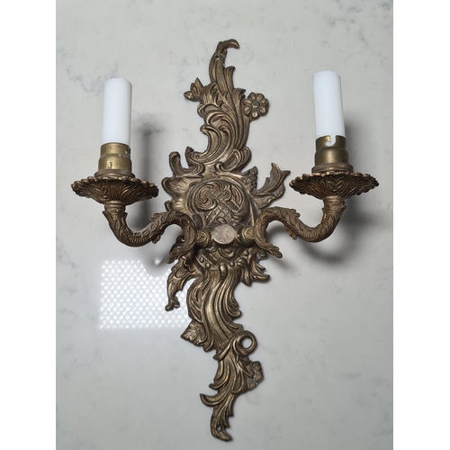 695 - A pair of gilt metal two branch Wall Light with rococo scrolls, 15in