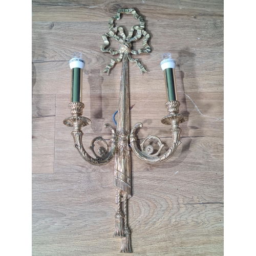 696 - A pair of gilt metal two branch Wall Lights with ribbon surmounts and tassels, 23in