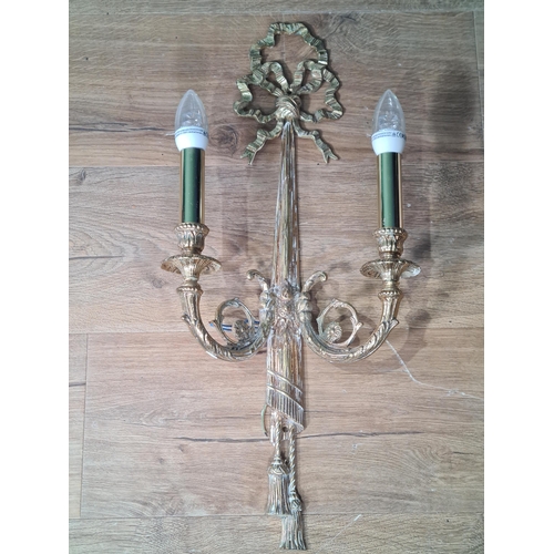 696 - A pair of gilt metal two branch Wall Lights with ribbon surmounts and tassels, 23in