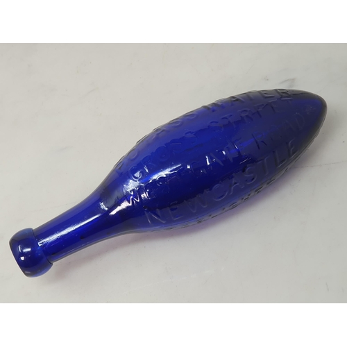 555 - A blue glass torpedo shape Fire Extinguisher by G Eland's Potass Water, Cross Street, Westgate Road,... 