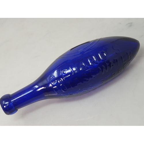 555 - A blue glass torpedo shape Fire Extinguisher by G Eland's Potass Water, Cross Street, Westgate Road,... 