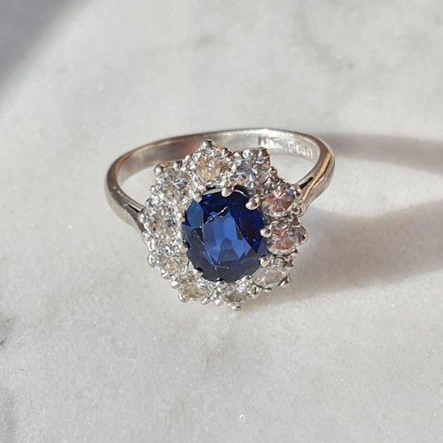 160 - A mid-century Sapphire and Diamond Cluster ring, claw-set oval mixed-cut sapphire, surrounded by ten... 