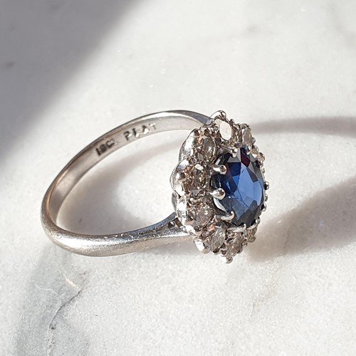 160 - A mid-century Sapphire and Diamond Cluster ring, claw-set oval mixed-cut sapphire, surrounded by ten... 