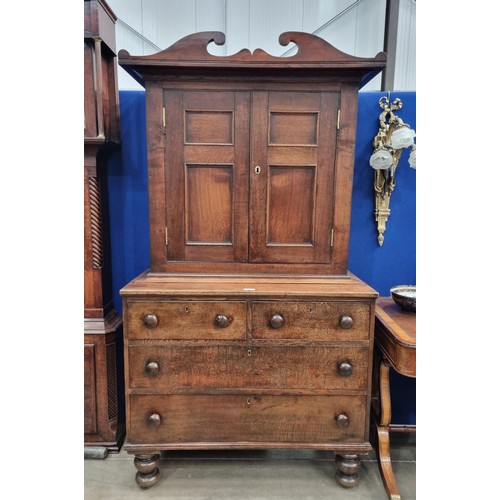 487 - A 19th Century oak Cupboard with shaped surmount above pair of panelled doors enclosing fitted shelv... 