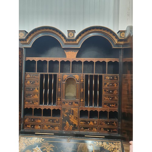 419 - A black lacquered and chinoiserie designed Bureau Bookcase having designs of figures and warriors in... 