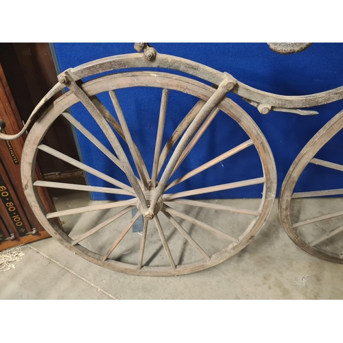 300 - A French Boneshaker Bicycle with turned wooden Handlebars, iron saddle and framework, wooden spoked ... 