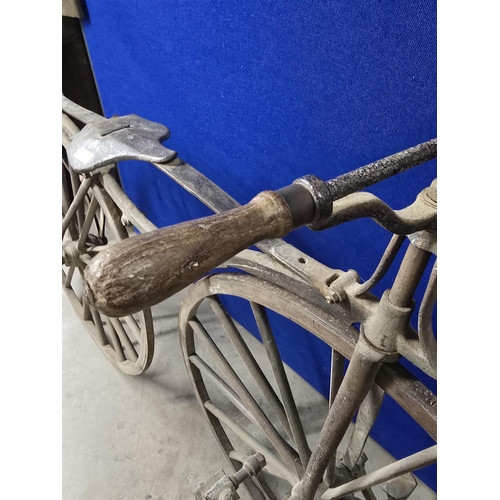 300 - A French Boneshaker Bicycle with turned wooden Handlebars, iron saddle and framework, wooden spoked ... 