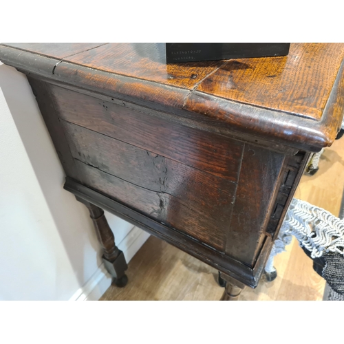 326 - An 18th century oak Dresser Base fitted with three frieze drawers and raised on six turned and squar... 