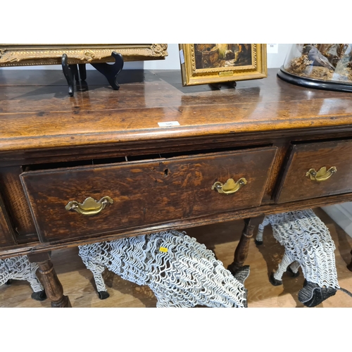 326 - An 18th century oak Dresser Base fitted with three frieze drawers and raised on six turned and squar... 