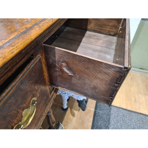 326 - An 18th century oak Dresser Base fitted with three frieze drawers and raised on six turned and squar... 