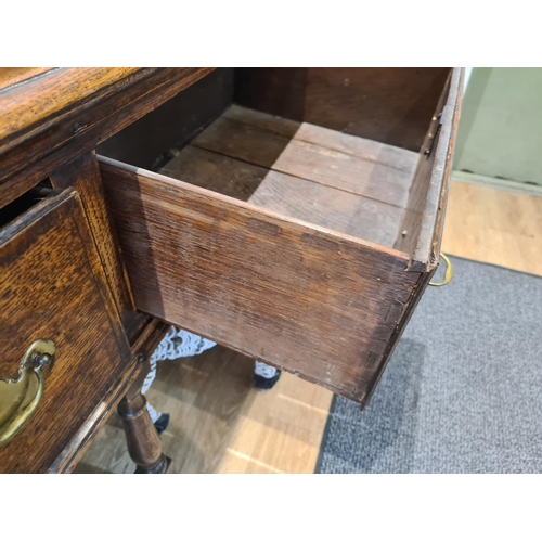 326 - An 18th century oak Dresser Base fitted with three frieze drawers and raised on six turned and squar... 