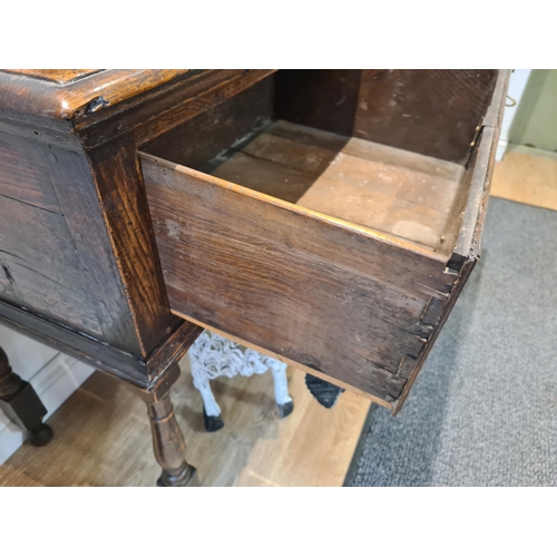 326 - An 18th century oak Dresser Base fitted with three frieze drawers and raised on six turned and squar... 