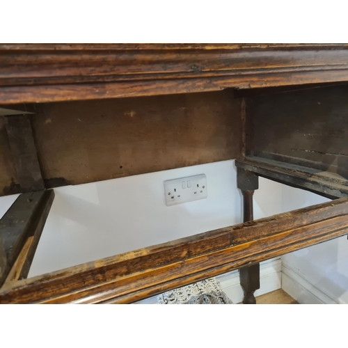 326 - An 18th century oak Dresser Base fitted with three frieze drawers and raised on six turned and squar... 