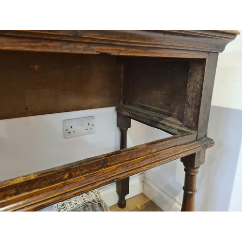 326 - An 18th century oak Dresser Base fitted with three frieze drawers and raised on six turned and squar... 