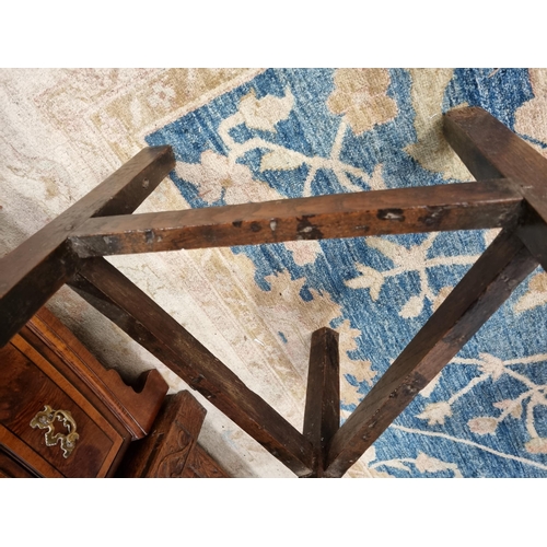 365 - An 18th Century oak Cricket Table with circular top on three triangular supports united by stretcher... 