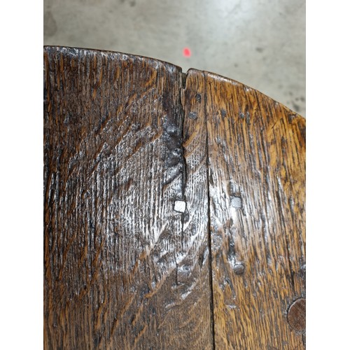 324 - A 19th Century oak Cricket Table, the circular top above turned column and an undertier, raised on t... 