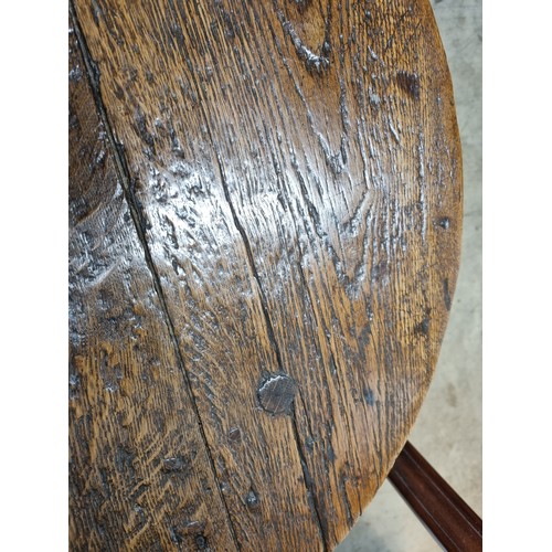 324 - A 19th Century oak Cricket Table, the circular top above turned column and an undertier, raised on t... 