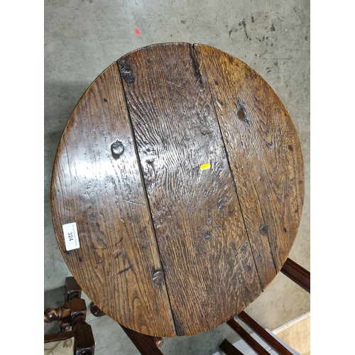 324 - A 19th Century oak Cricket Table, the circular top above turned column and an undertier, raised on t... 