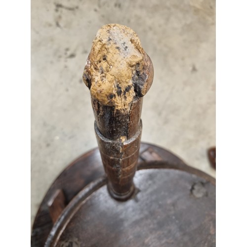 324 - A 19th Century oak Cricket Table, the circular top above turned column and an undertier, raised on t... 