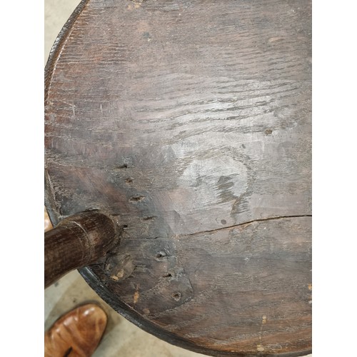 324 - A 19th Century oak Cricket Table, the circular top above turned column and an undertier, raised on t... 