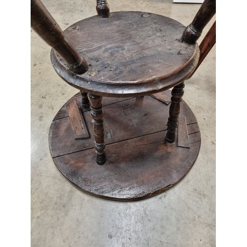 324 - A 19th Century oak Cricket Table, the circular top above turned column and an undertier, raised on t... 