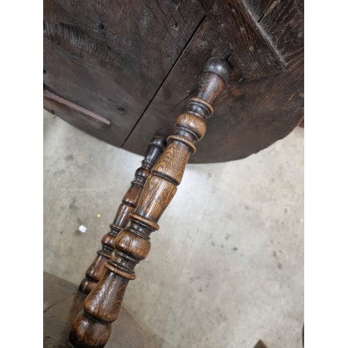 324 - A 19th Century oak Cricket Table, the circular top above turned column and an undertier, raised on t... 