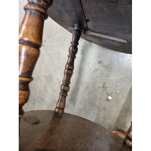 324 - A 19th Century oak Cricket Table, the circular top above turned column and an undertier, raised on t... 