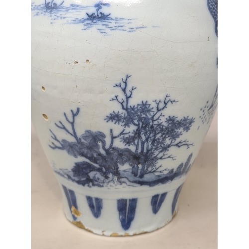 45 - A 17th Century delftware Meiping type Vase, in blue and white glaze, with Oriental landscape with fi... 