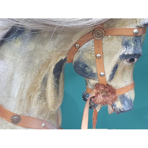 49 - A Victorian carved and painted dapple gray Rocking Horse in the manner of F.H. Ayres, with leather b... 