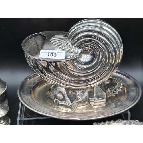 103 - A plated Spoon Warmer in the form of a nautilus shell, a Brandy Saucepan, two Coasters, Sauce Boat, ... 