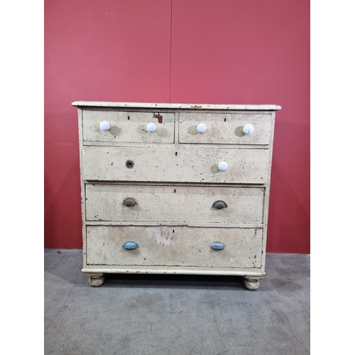 14 - A cream painted pine Chest of two short over three long graduated Drawers, raised on turned bun feet... 
