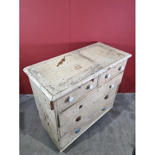 14 - A cream painted pine Chest of two short over three long graduated Drawers, raised on turned bun feet... 