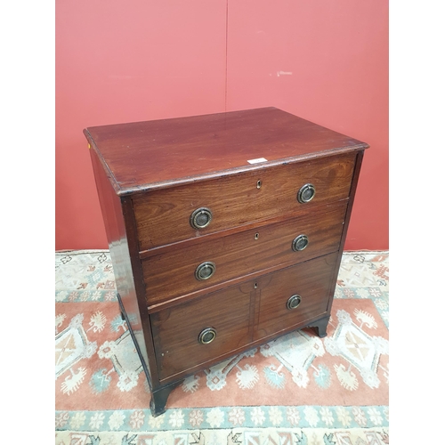 17 - A small mahogany Chest of three graduated drawers with ring handles, raised on shaped bracket suppor... 
