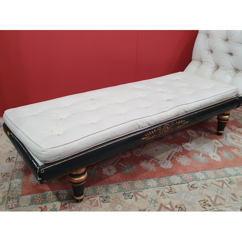 18 - A cream button upholstered miniature Chaise Longue/Day Bed, the painted frame with gilt floral and s... 
