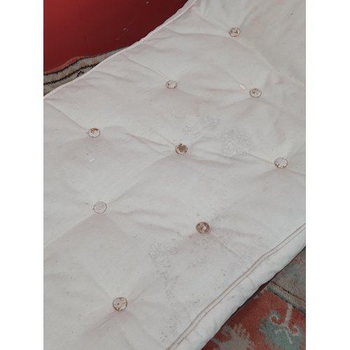 18 - A cream button upholstered miniature Chaise Longue/Day Bed, the painted frame with gilt floral and s... 